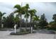 Entrance to property with well manicured shrubs and guest sign at 8325 38Th Street E Cir # 101, Sarasota, FL 34243