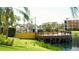 Waterfront terrace with tables, chairs, and umbrellas with buildings in the background at 8325 38Th Street E Cir # 101, Sarasota, FL 34243