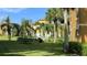 Beautifully landscaped exterior view of the property featuring palm trees and a picnic area at 8325 38Th Street E Cir # 101, Sarasota, FL 34243