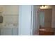 Convenient laundry area featuring a washing machine and dryer, adjacent to a bathroom at 8325 38Th Street E Cir # 101, Sarasota, FL 34243