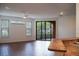 Bright living room featuring wood floors, ceiling fan, with sliding glass doors to balcony at 8325 38Th Street E Cir # 101, Sarasota, FL 34243