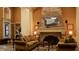 A cozy living room with comfortable seating and a stone fireplace at 8325 38Th Street E Cir # 101, Sarasota, FL 34243