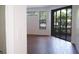 Cozy living room with wood floors and glass sliding doors leading to outdoor balcony at 8325 38Th Street E Cir # 101, Sarasota, FL 34243