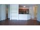 Open-concept living area with dark wood floors flows into a modern kitchen with stainless steel appliances at 8325 38Th Street E Cir # 101, Sarasota, FL 34243