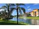 Scenic view of a pond with fountains in a lush community at 8325 38Th Street E Cir # 101, Sarasota, FL 34243