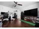Open-concept living room with ceiling fan, modern furnishings, and dark hardwood flooring at 9207 59Th Avenue E Dr, Bradenton, FL 34202