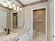 Elegant bathroom with vanity, decorative mirror, and a separate toilet room at 9630 Club South Cir # 6204, Sarasota, FL 34238