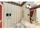 Elegant bathroom with decorative wallpaper, vanity, and a large mirror at 9630 Club South Cir # 6204, Sarasota, FL 34238