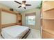 Bright bedroom with a built-in murphy bed and wall to wall shelving at 9630 Club South Cir # 6204, Sarasota, FL 34238