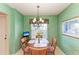 Cozy dining room with a charming chandelier and an outdoor view from the window at 9630 Club South Cir # 6204, Sarasota, FL 34238