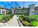 Three-story condo complex with mature landscaping and palm trees at 9630 Club South Cir # 6204, Sarasota, FL 34238