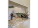 Granite countertop bar area showcases the open kitchen with white cabinets and stainless steel appliances at 9630 Club South Cir # 6204, Sarasota, FL 34238