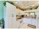 Bright kitchen featuring white cabinets, a window, a ceiling fan, and modern appliances and countertops at 9630 Club South Cir # 6204, Sarasota, FL 34238