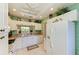 Bright kitchen featuring white cabinets, a window, a ceiling fan, and modern appliances and countertops at 9630 Club South Cir # 6204, Sarasota, FL 34238