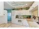 Bright kitchen featuring white cabinets, a window, a ceiling fan, and modern appliances and countertops at 9630 Club South Cir # 6204, Sarasota, FL 34238