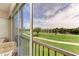 Enclosed lanai with comfortable seating and a beautiful view of the golf course and pond at 9630 Club South Cir # 6204, Sarasota, FL 34238