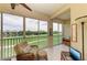 Enclosed lanai with tile floor, wicker furniture, golf course view at 9630 Club South Cir # 6204, Sarasota, FL 34238