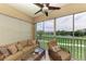 Enclosed lanai with tile floor, ceiling fan, comfortable seating and a beautiful view of the golf course and pond at 9630 Club South Cir # 6204, Sarasota, FL 34238