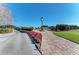 Clock and flower bed at the entrance of the community at 9630 Club South Cir # 6204, Sarasota, FL 34238