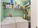 Laundry room featuring a washer, dryer, and shelving for storage at 9630 Club South Cir # 6204, Sarasota, FL 34238