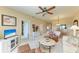 Inviting living space with ceiling fan, a sitting area and views through the opening into the dining area at 9630 Club South Cir # 6204, Sarasota, FL 34238
