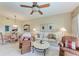 Cozy living room featuring a ceiling fan, plush furniture, and bright dining area in a naturally lit space at 9630 Club South Cir # 6204, Sarasota, FL 34238