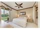 Comfortable main bedroom featuring a ceiling fan, neutral tones, and sliding glass doors leading to the lanai at 9630 Club South Cir # 6204, Sarasota, FL 34238