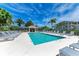 Community pool with cabana, lounge chairs, umbrellas, and clear blue water at 9630 Club South Cir # 6204, Sarasota, FL 34238