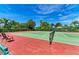 Well-maintained tennis court with shade trees and seating at 9630 Club South Cir # 6204, Sarasota, FL 34238