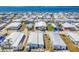 Expansive aerial view of a waterfront community with white rooftops and lush palm trees at 10315 Cortez W Rd # 24H, Bradenton, FL 34210