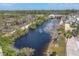 Aerial view of lake with fountain feature, walking paths, and gazebo in a tranquil community at 10315 Cortez W Rd # 24H, Bradenton, FL 34210