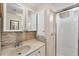 Well-lit bathroom with modern vanity, tiled backsplash, storage and a clean, enclosed shower area at 10315 Cortez W Rd # 24H, Bradenton, FL 34210