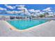 A refreshing community pool with ample seating for residents to relax and soak up the sun at 10315 Cortez W Rd # 24H, Bradenton, FL 34210