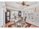 Charming dining room with a glass table, decorative ceiling fan, and bright windows at 10315 Cortez W Rd # 24H, Bradenton, FL 34210