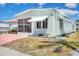 Well-maintained single-story home with a screened in porch, a carport, and lush landscaping at 10315 Cortez W Rd # 24H, Bradenton, FL 34210