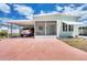 Charming single-story home with a carport, screened porch, and manicured landscaping at 10315 Cortez W Rd # 24H, Bradenton, FL 34210