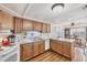 Functional kitchen with wooden cabinets, standard appliances, and connected dining area at 10315 Cortez W Rd # 24H, Bradenton, FL 34210
