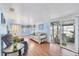 Open living room showcasing natural light, sliding glass doors, and comfortable seating at 10315 Cortez W Rd # 24H, Bradenton, FL 34210