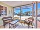 Relaxing screened porch with wicker furniture, a table, and peaceful community views at 10315 Cortez W Rd # 24H, Bradenton, FL 34210
