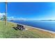 A serene water view features a bench along the grassy waterfront offering a peaceful spot to relax and enjoy the scenery at 10315 Cortez W Rd # 24H, Bradenton, FL 34210