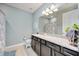 A neutral bathroom showcases a granite countertop vanity and a decorative framed mirror at 11092 58Th Street Cir E, Parrish, FL 34219