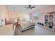 Charming bedroom features a swinging chair, large bed, and a pink color palette at 11092 58Th Street Cir E, Parrish, FL 34219