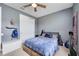 Simple bedroom with a double bed, closet, and a ceiling fan. Decorated with a USA flag at 11092 58Th Street Cir E, Parrish, FL 34219