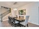 Bright dining room with hardwood floors, modern light fixtures, and a staircase at 11092 58Th Street Cir E, Parrish, FL 34219