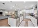 Open concept kitchen with stainless steel appliances, granite countertops, and an island overlooking the living room at 11092 58Th Street Cir E, Parrish, FL 34219