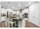 Close up of a stylish kitchen with white cabinets, stainless steel appliances, granite countertops, and pendant lighting at 11092 58Th Street Cir E, Parrish, FL 34219