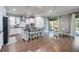 Bright kitchen features white cabinets, stainless steel appliances, a center island, and an adjacent dining area at 11092 58Th Street Cir E, Parrish, FL 34219