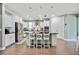 Well-lit kitchen with white cabinets, granite countertops, stainless steel appliances, and a center island with seating at 11092 58Th Street Cir E, Parrish, FL 34219