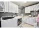 The laundry room has modern appliances, ample cabinets, and a folding rack at 11092 58Th Street Cir E, Parrish, FL 34219
