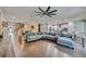 Bright open-concept living space with modern furniture and a view of the dining area and kitchen at 11092 58Th Street Cir E, Parrish, FL 34219